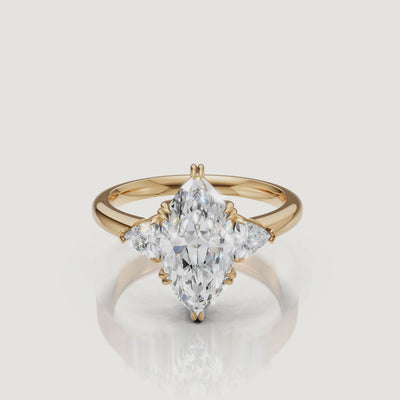 video of marquise cut lab grown diamond engagement ring with trillion side stones in 14k yellow gold