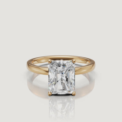 High-definition product video of a Raul Diamonds radiant cut solitaire ring in yellow gold, highlighting the crushed-ice sparkle and classic gold band.