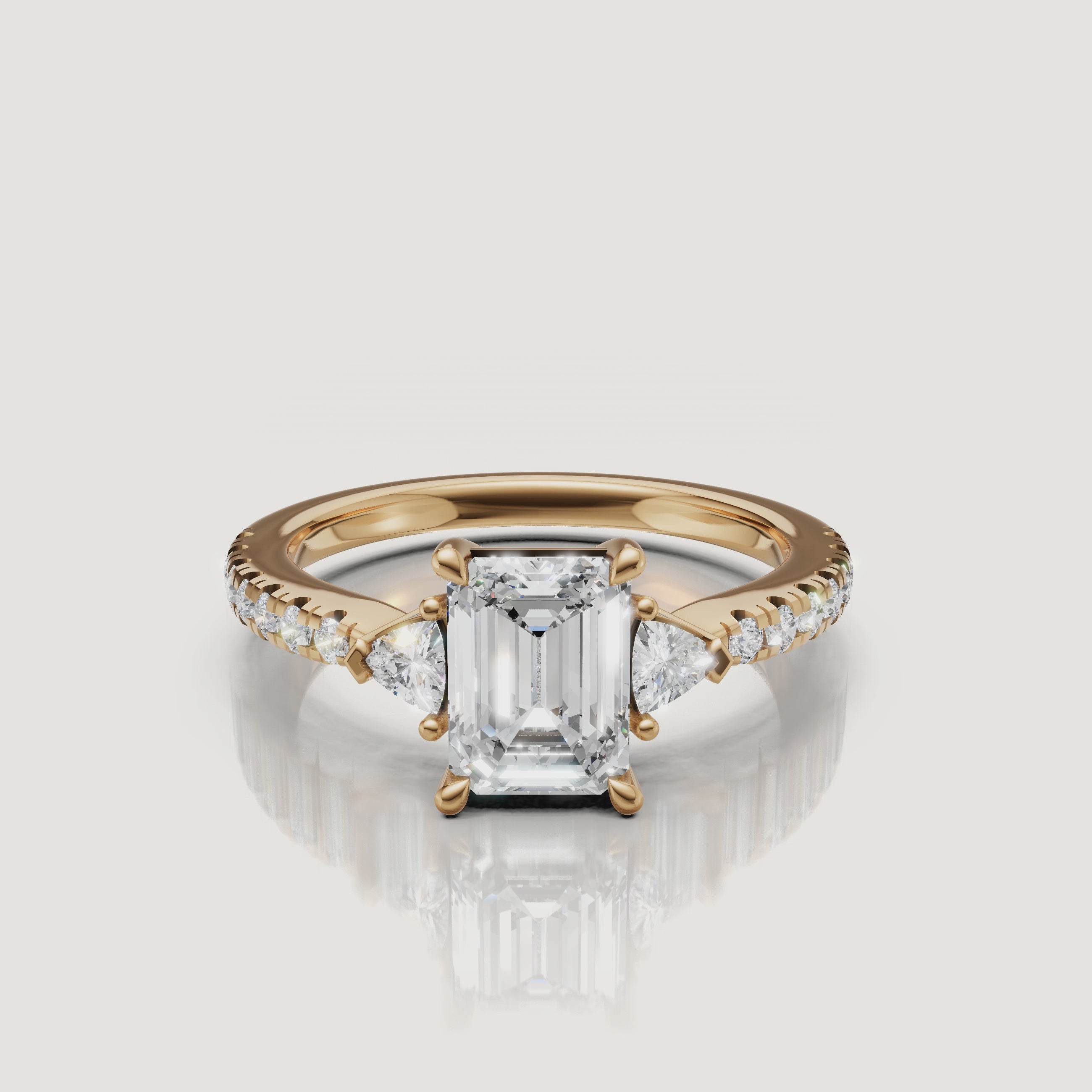 A high-definition 360-degree rotation of a Rual Diamonds emerald cut engagement ring, showcasing the brilliant trillion-cut side stones and the shimmering pavé-set diamond band.