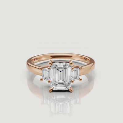 Cinematic close-up of a Rual Diamonds two-stone emerald cut diamond ring in rose gold, capturing the romantic warmth and exceptional fire of the modern Toi et Moi design in motion