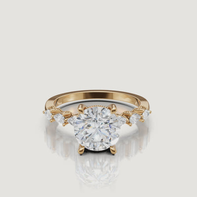 Video of round cut lab grown diamond engagement ring in 14K yellow gold with marquise side stones by Raul Diamonds