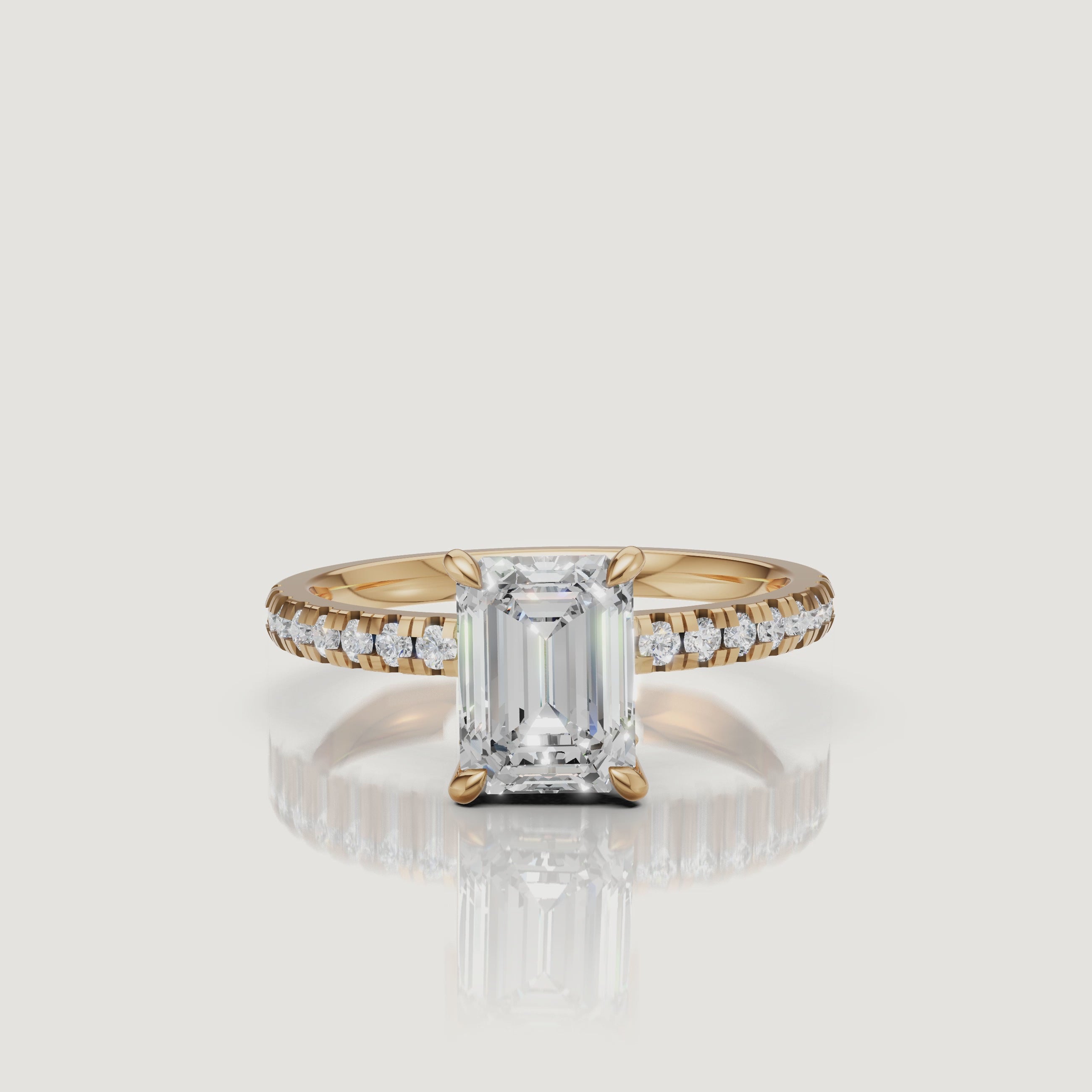 High-definition 360-degree video of a Raul Diamonds emerald cut engagement ring in 18k yellow gold, featuring a shimmering pavé-set diamond band and a 4-prong claw setting