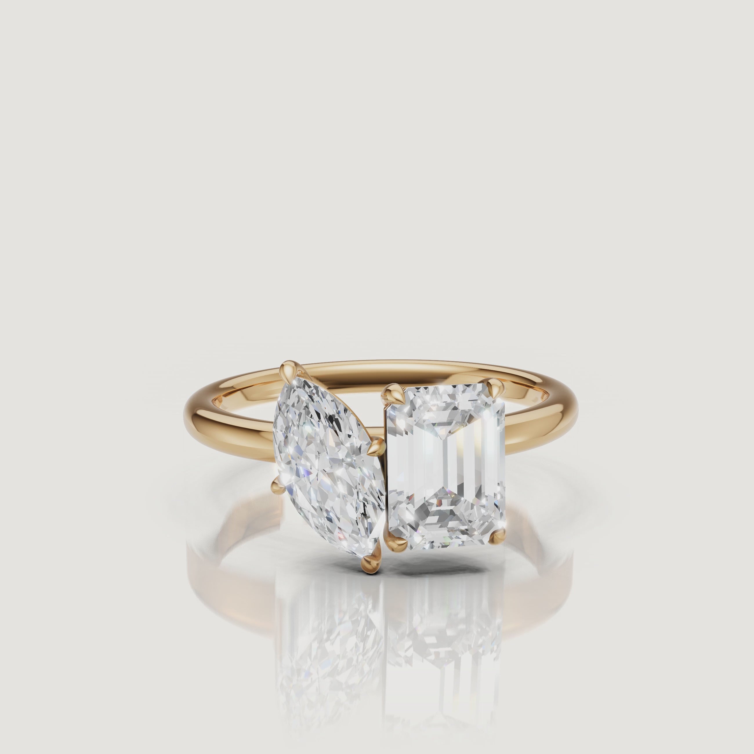 Yellow Gold Video Alt: Rotating video of Raul Diamonds yellow gold toi et moi ring with marquise and emerald cut diamonds