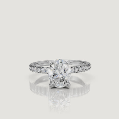 Professional 360-degree video of a white gold oval diamond ring, emphasizing the icy brilliance of the center stone and the seamless pavé setting.