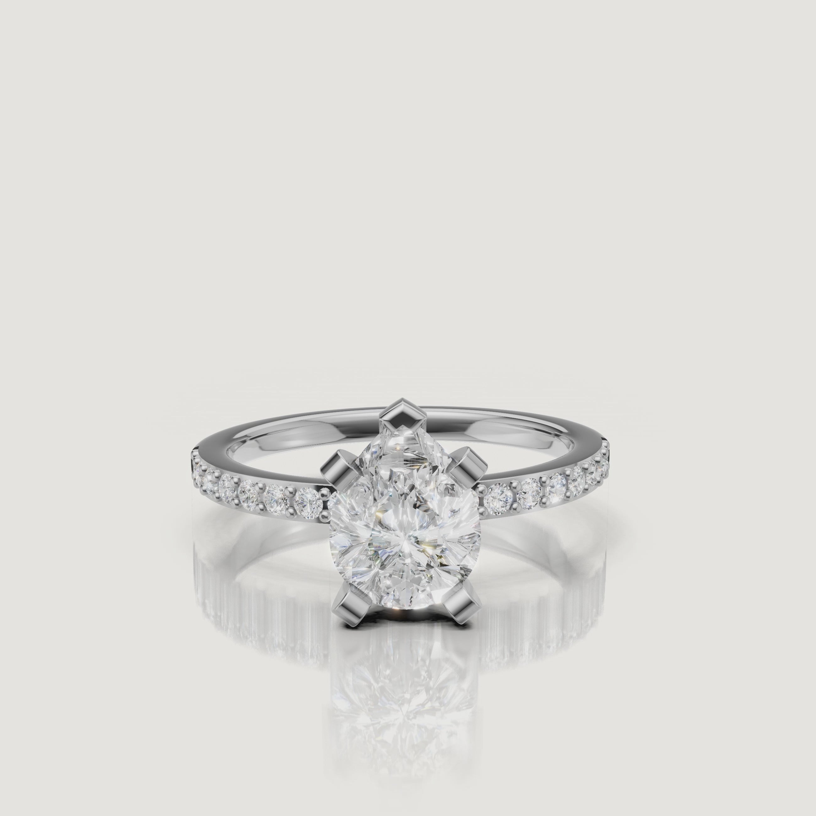 High-definition video of the Raul Diamonds white gold pear cut engagement ring, focusing on the crisp facets of the diamond and the seamless brilliance of the pavé setting.