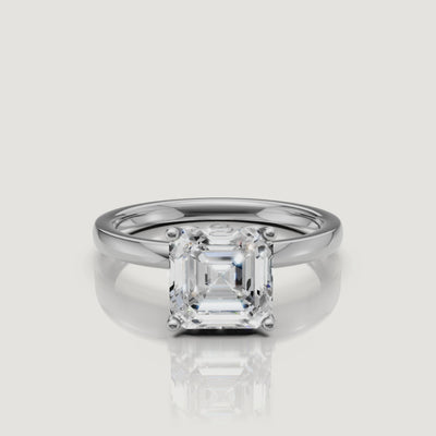Cinematic video of a white gold Asscher cut diamond engagement ring from Raul Diamonds, demonstrating the 'hall of mirrors' effect of the square step-cut center stone
