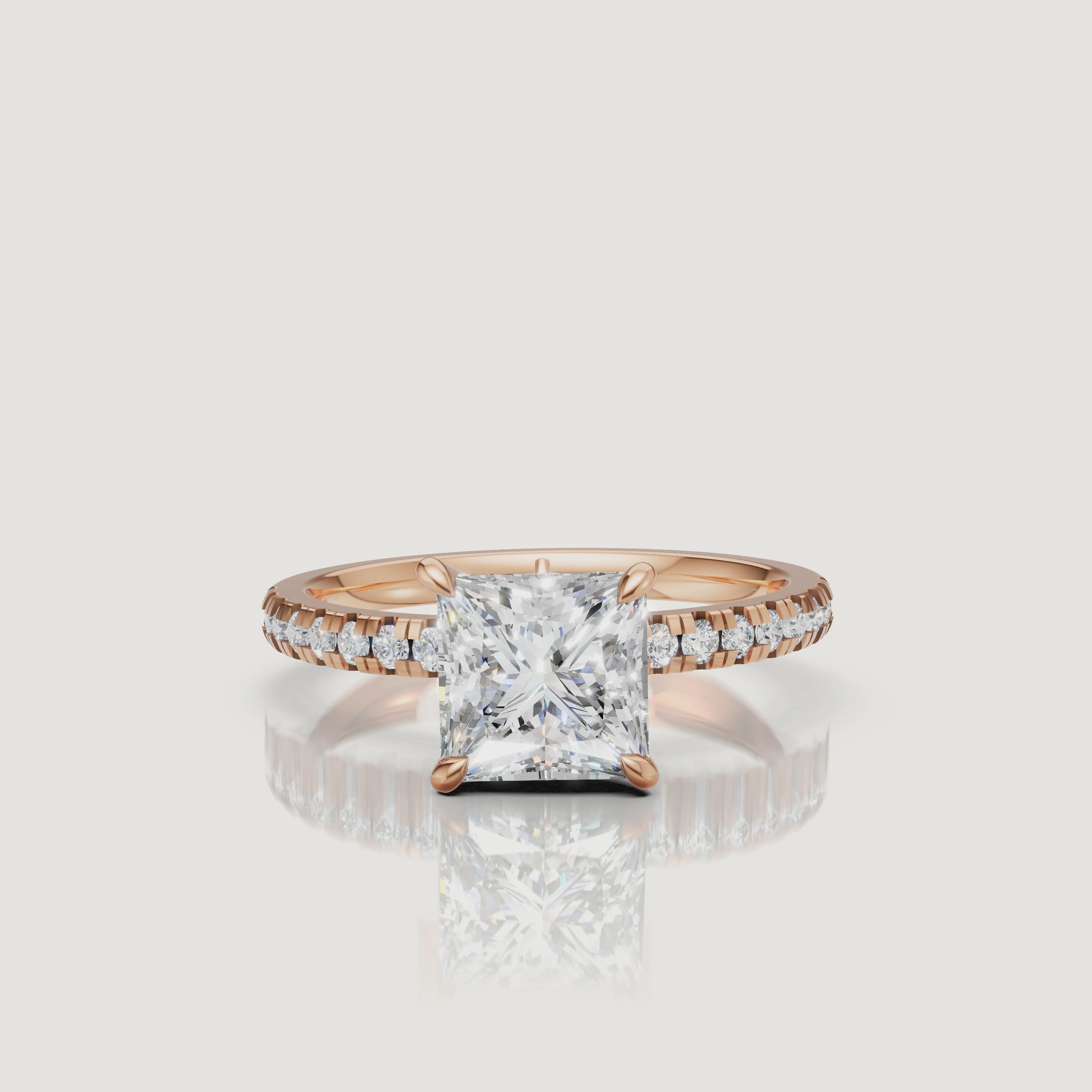 "High-definition video showcase of a rose gold princess-cut diamond engagement ring, focusing on the romantic blush tones and the high-clarity reflections of the step-cut stone."