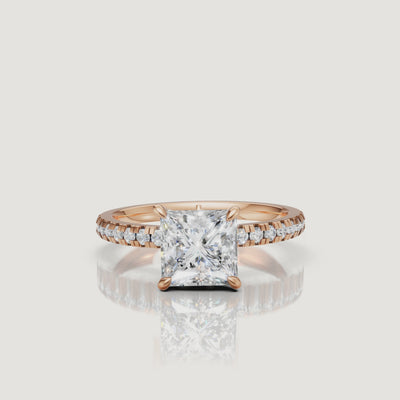 "High-definition video showcase of a rose gold princess-cut diamond engagement ring, focusing on the romantic blush tones and the high-clarity reflections of the step-cut stone."