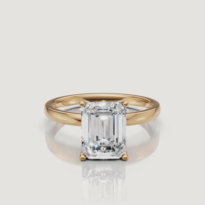 Product video of a Raul Diamonds emerald cut solitaire ring in yellow gold, rotating to show the linear facets and the high-polish 14k gold setting
