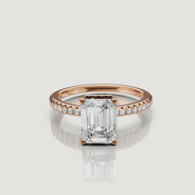 Close-up video of a Raul Diamonds rose gold emerald cut ring, highlighting the sophisticated step-cut facets and pink gold pavé band