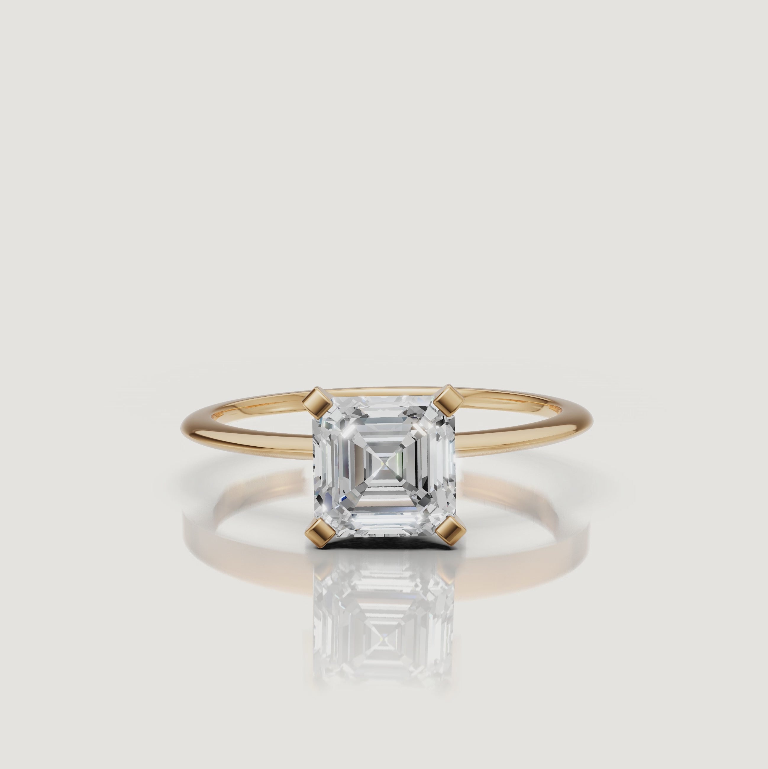 Cinematic video of an asscher cut lab grown diamond solitaire engagement ring in yellow gold by Raul Diamonds featuring elegant hand movement, macro diamond sparkle, warm luxury lighting, and premium bridal jewelry styling