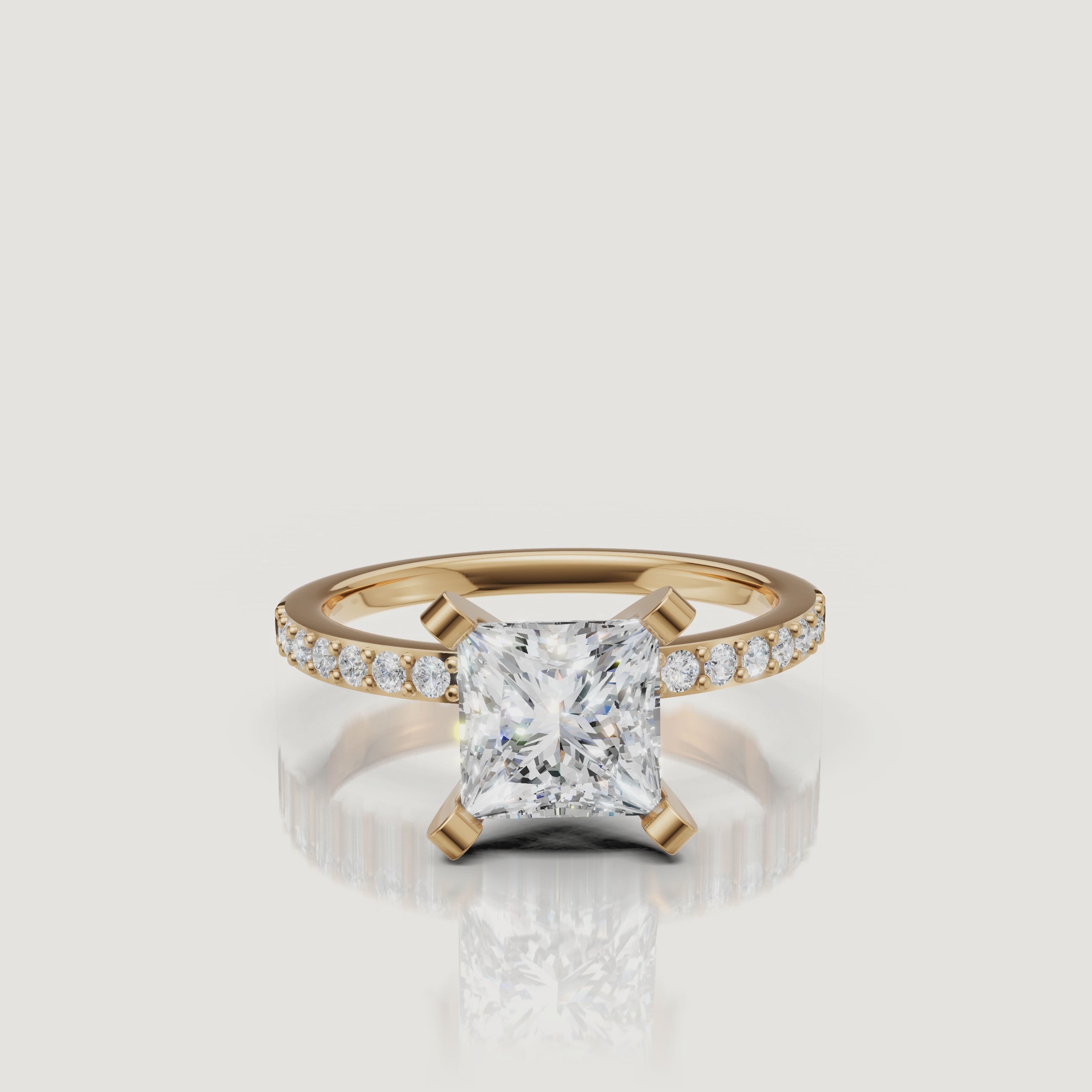 360-degree video of the Raul Diamonds princess cut three-stone ring in yellow gold, featuring brilliant light return from the center stone and tapered baguette side diamonds.