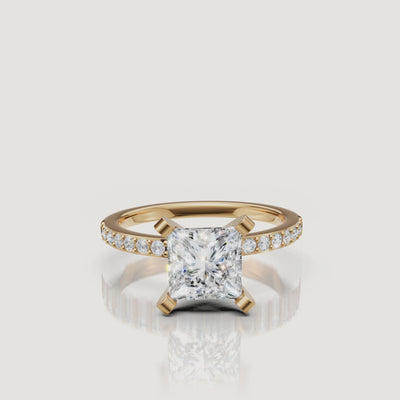 360-degree video of the Raul Diamonds princess cut three-stone ring in yellow gold, featuring brilliant light return from the center stone and tapered baguette side diamonds.