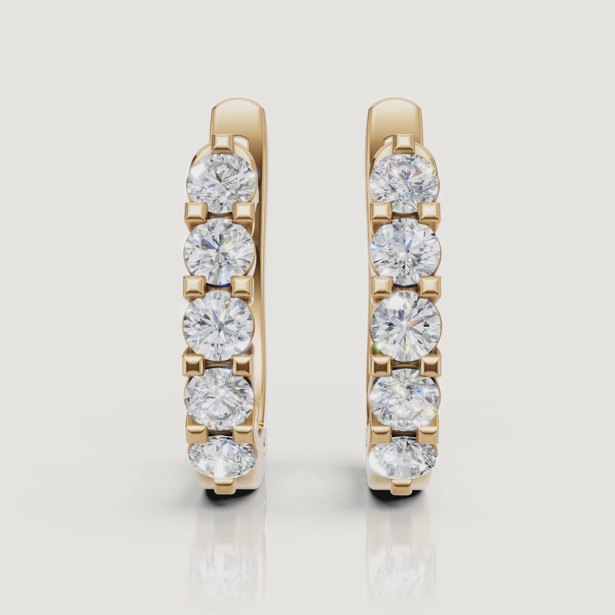 Yellow gold diamond hoop earrings video featuring sparkling round lab grown diamonds in a luxury fine jewelry style by Raul Diamonds