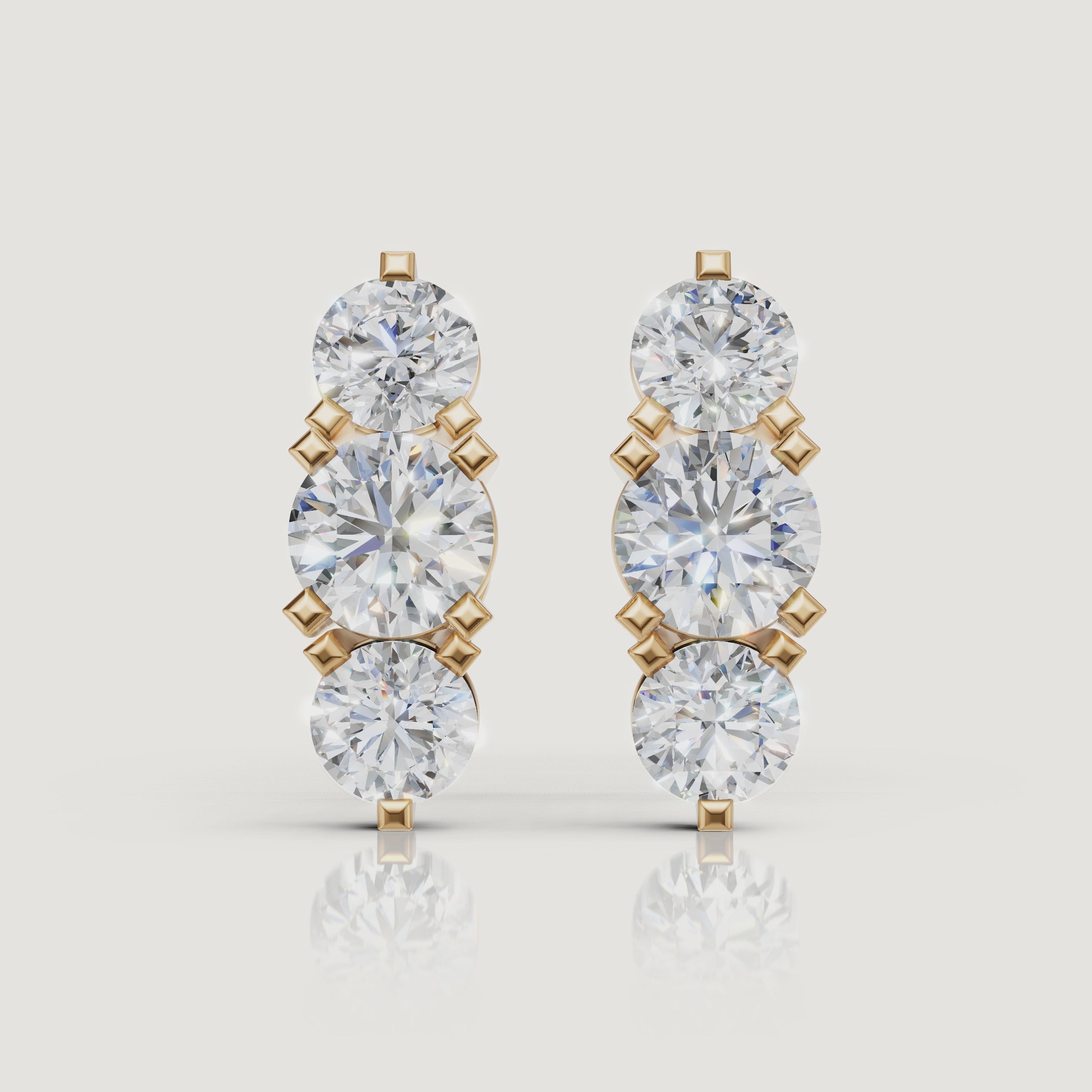 Yellow gold three stone diamond earrings cinematic jewelry video by Raul Diamonds