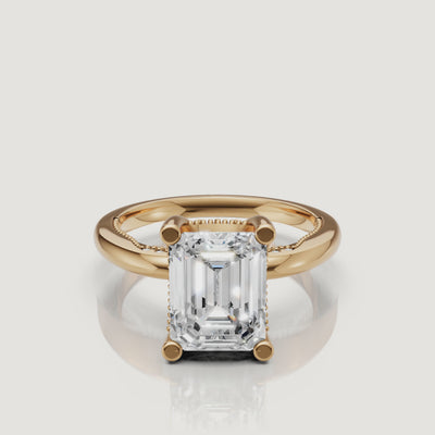 A 360-degree high-definition video of a Raul Diamonds emerald cut ring in 18k yellow gold, highlighting the hall-of-mirrors light effect
