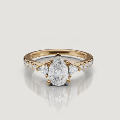 High-definition 360-degree rotation of a Rual Diamonds pear-shaped engagement ring, highlighting the brilliant teardrop profile and trillion side stones