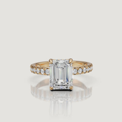 Showcase video of a Raul Diamonds emerald-cut engagement ring in yellow gold, demonstrating the 'hall of mirrors' effect of the step-cut facets and pavé sparkle
