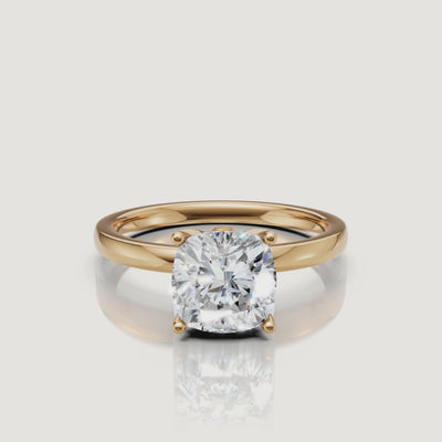 Detailed product video of a Raul Diamonds cushion cut solitaire ring in yellow gold, showcasing the fire and brilliance of the rounded-corner diamond.