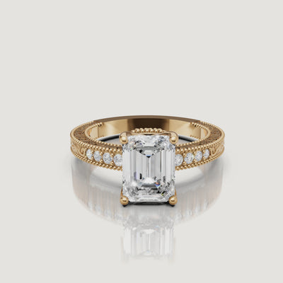 360 video of vintage emerald cut lab grown diamond engagement ring in 14K yellow gold with ornate filigree detailing by Raul Diamonds.