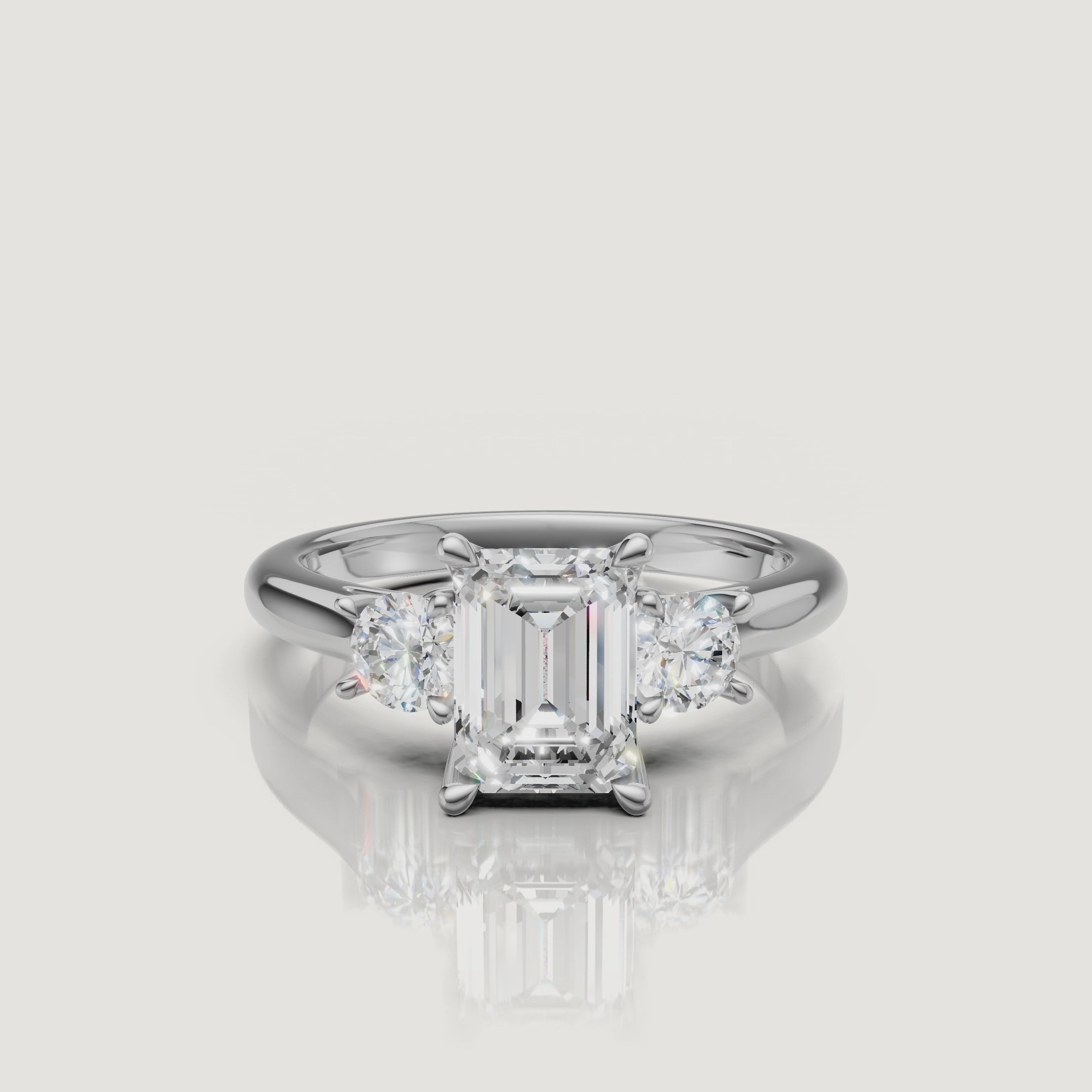 High-definition video of the Raul Diamonds white gold emerald cut three-stone engagement ring, demonstrating the brilliant contrast between the emerald and round diamond cuts.