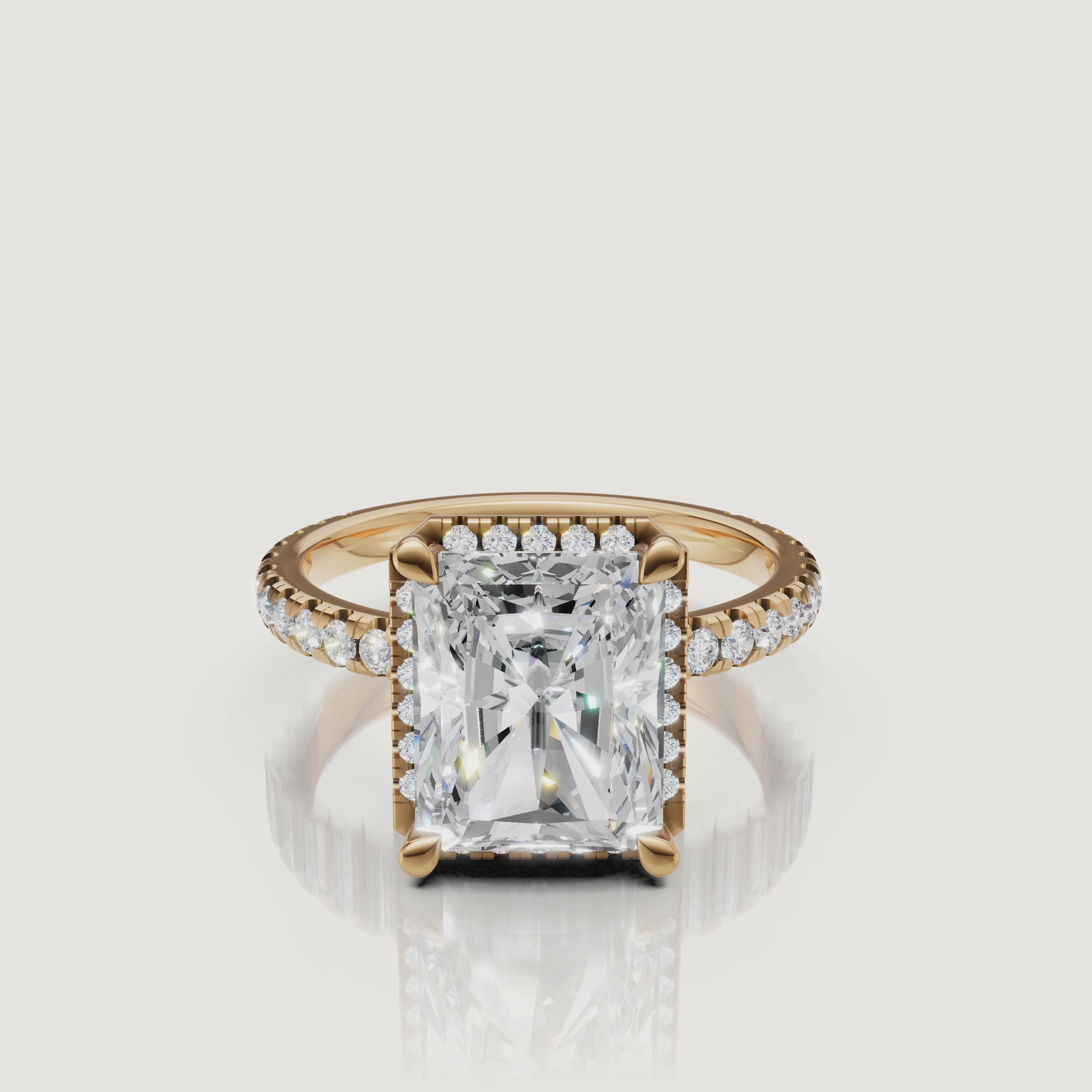 Cinematic 360-degree rotation of a Raul Diamonds Radiant Cut Hidden Halo ring in 18k yellow gold with a shimmering pavé diamond shank
