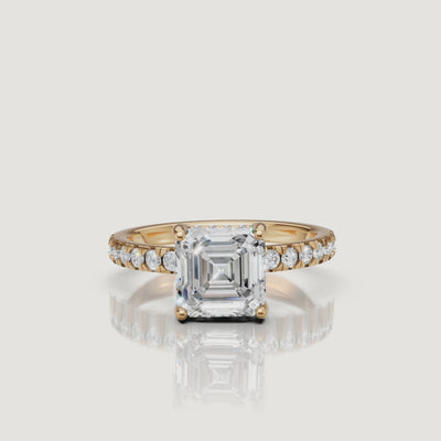 360-degree video showcase of a Raul Diamonds Asscher cut engagement ring in 18k yellow gold, featuring a brilliant pave diamond band and high-polish finish