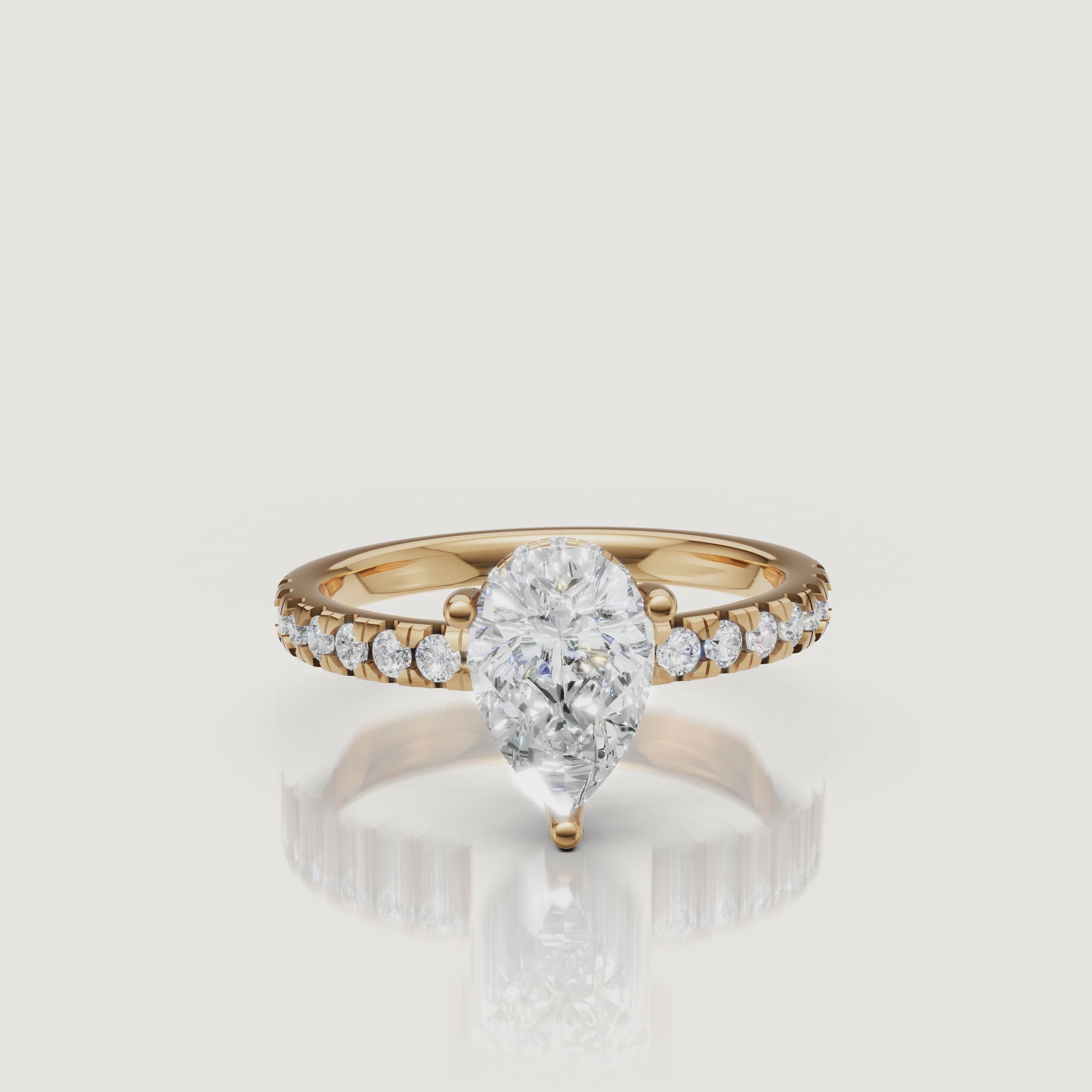 Pear cut lab grown diamond engagement ring video featuring elegant sparkle, pavé diamond band shimmer, yellow gold setting, and luxury bridal hand styling by Raul Diamonds