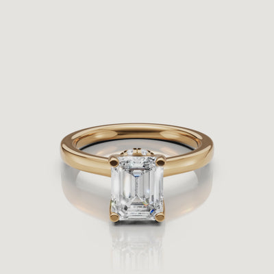 video of emerald cut lab grown diamond solitaire engagement ring in 14k yellow gold with hidden halo