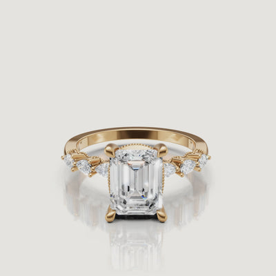 Video of emerald cut lab grown diamond engagement ring in 14K yellow gold with marquise side stones and hidden halo by Raul Diamonds