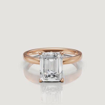 Cinematic video of a rose gold emerald cut diamond ring by Raul Diamonds, highlighting the sophisticated contrast between the warm metal and the rectangular diamond brilliance