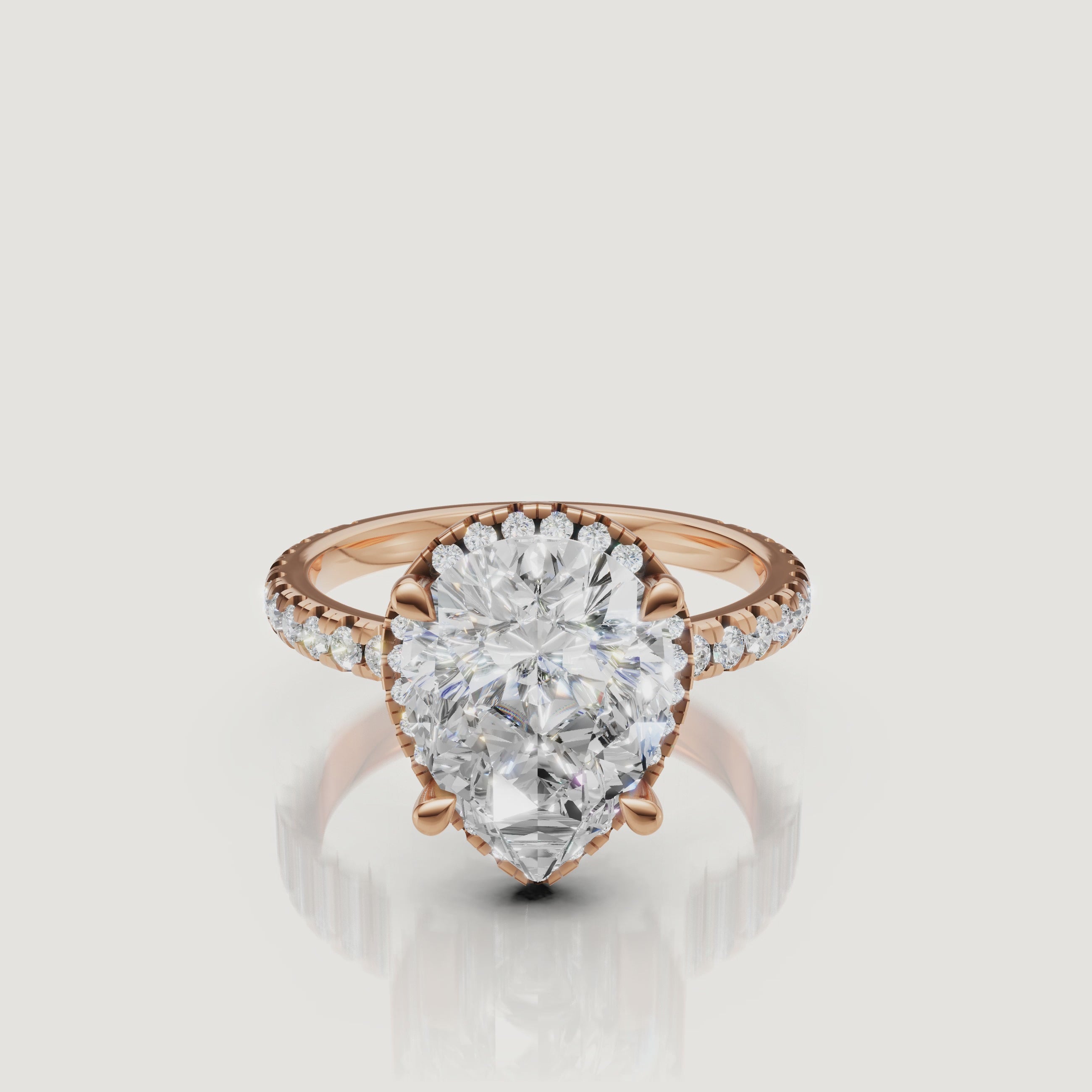 Macro sparkle test video of a rose gold Pear diamond ring featuring a delicate hidden halo and micro-pavé setting by Raul Diamonds