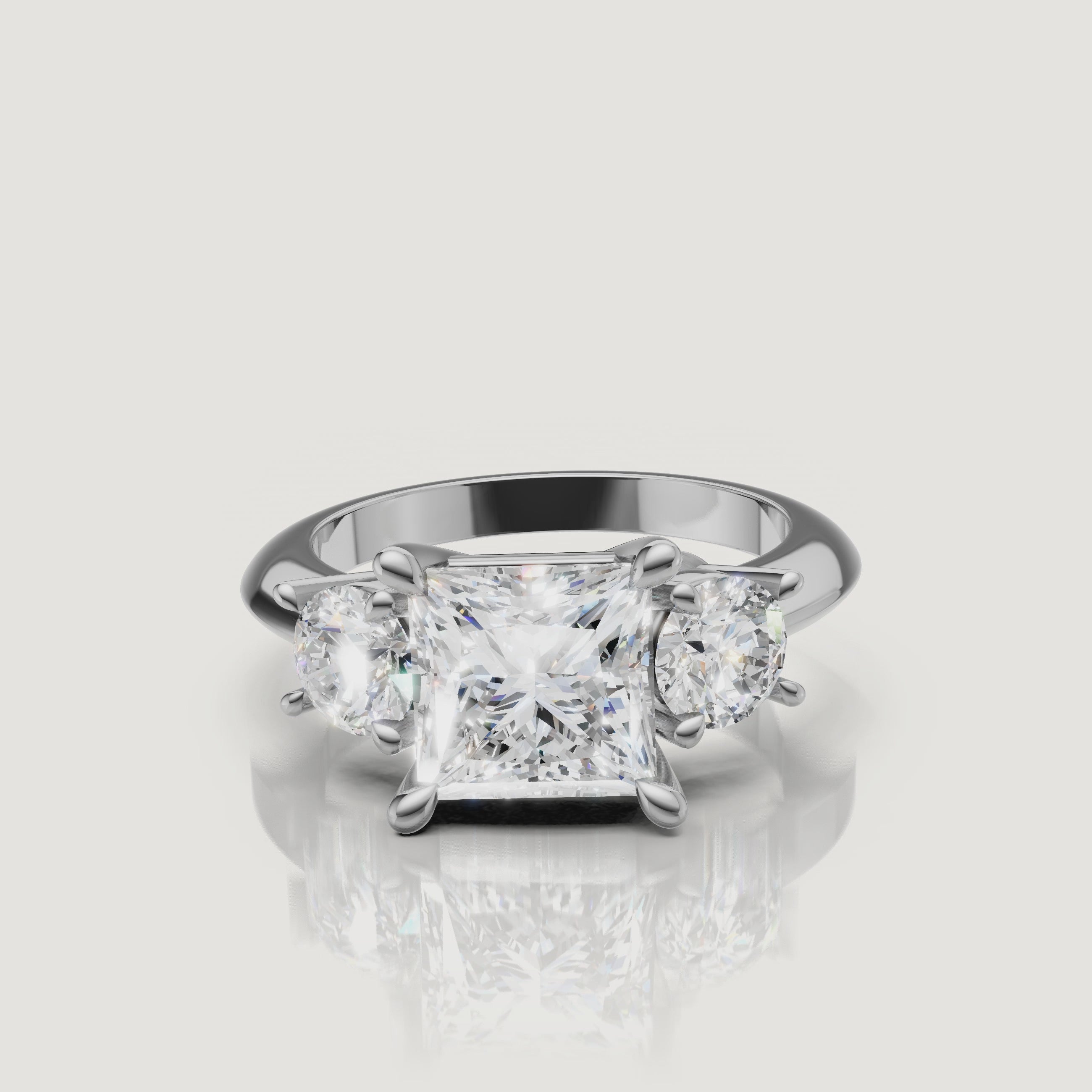 High-definition video of the Raul Diamonds white gold princess three-stone engagement ring, demonstrating the seamless brilliance and modern elegance of the trilogy setting.