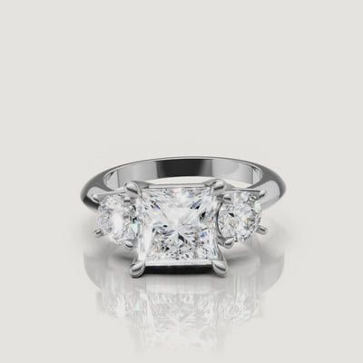 High-definition video of the Raul Diamonds white gold princess three-stone engagement ring, demonstrating the seamless brilliance and modern elegance of the trilogy setting.