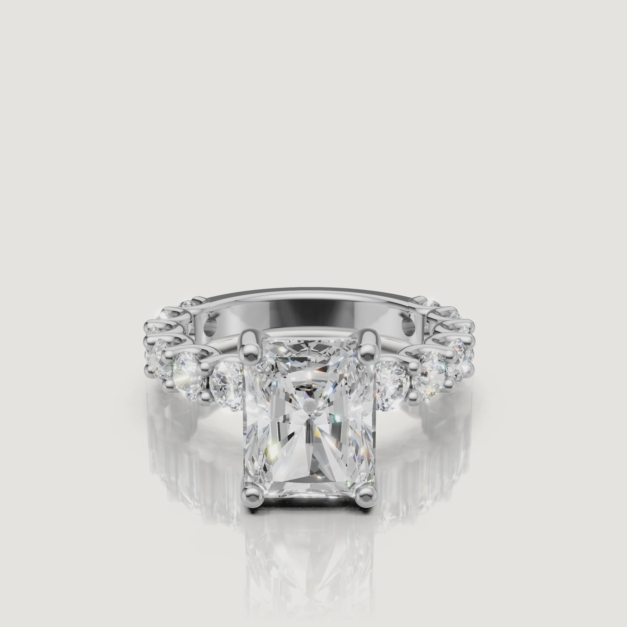 High-definition 360-degree profile view of a white gold radiant-cut diamond ring from Raul Diamonds, emphasizing the secure prong setting and brilliant side profile