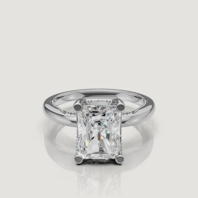 Macro video showcase of a white gold radiant cut solitaire ring by Raul Diamonds, displaying the trimmed corners and brilliant white fire.