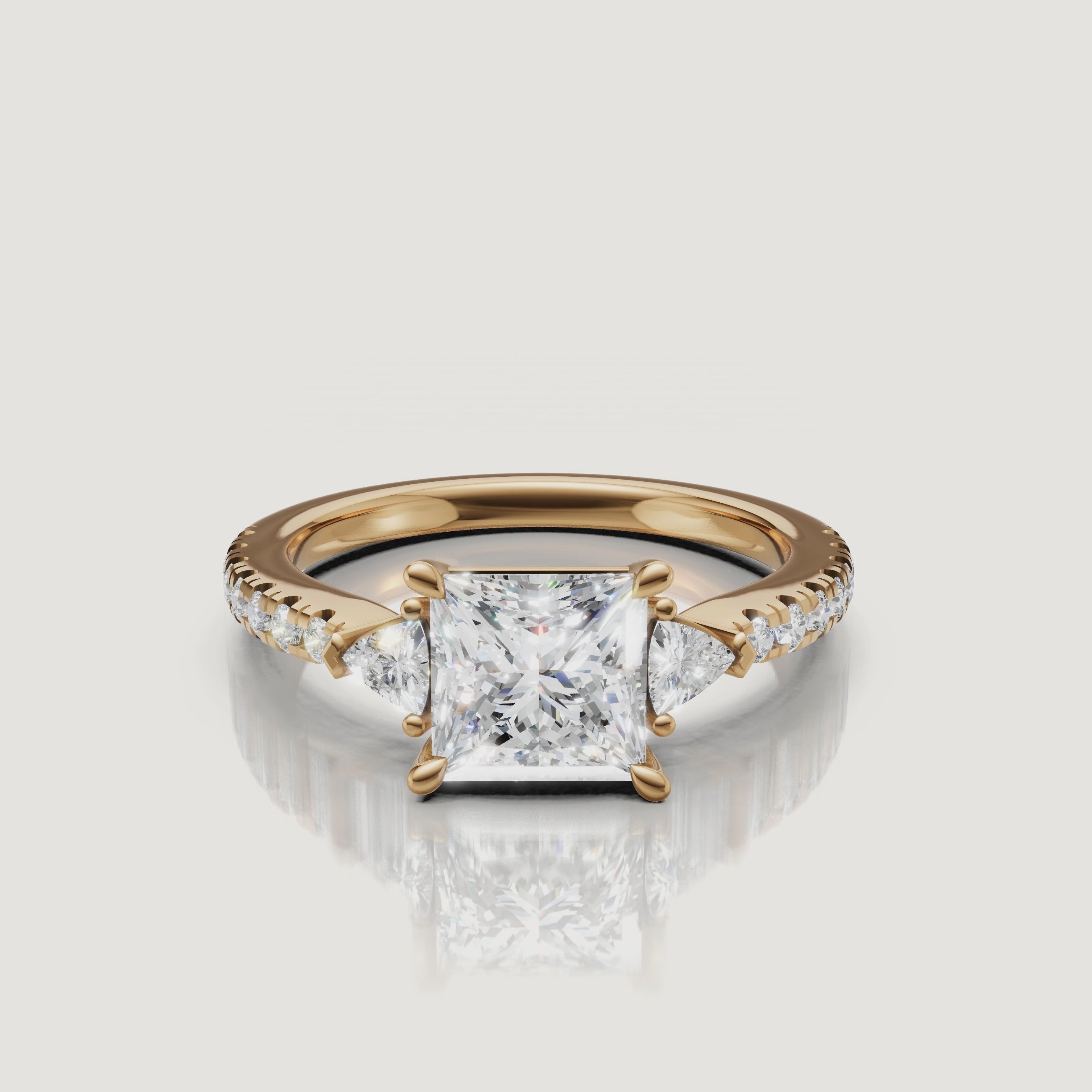 A high-definition 360-degree rotation of a Rual Diamonds princess-cut three-stone ring, highlighting the brilliant square facets and shimmering trillion-cut side accents