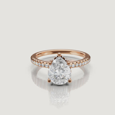 close up video of pear shaped lab diamond solitaire ring in 14k gold