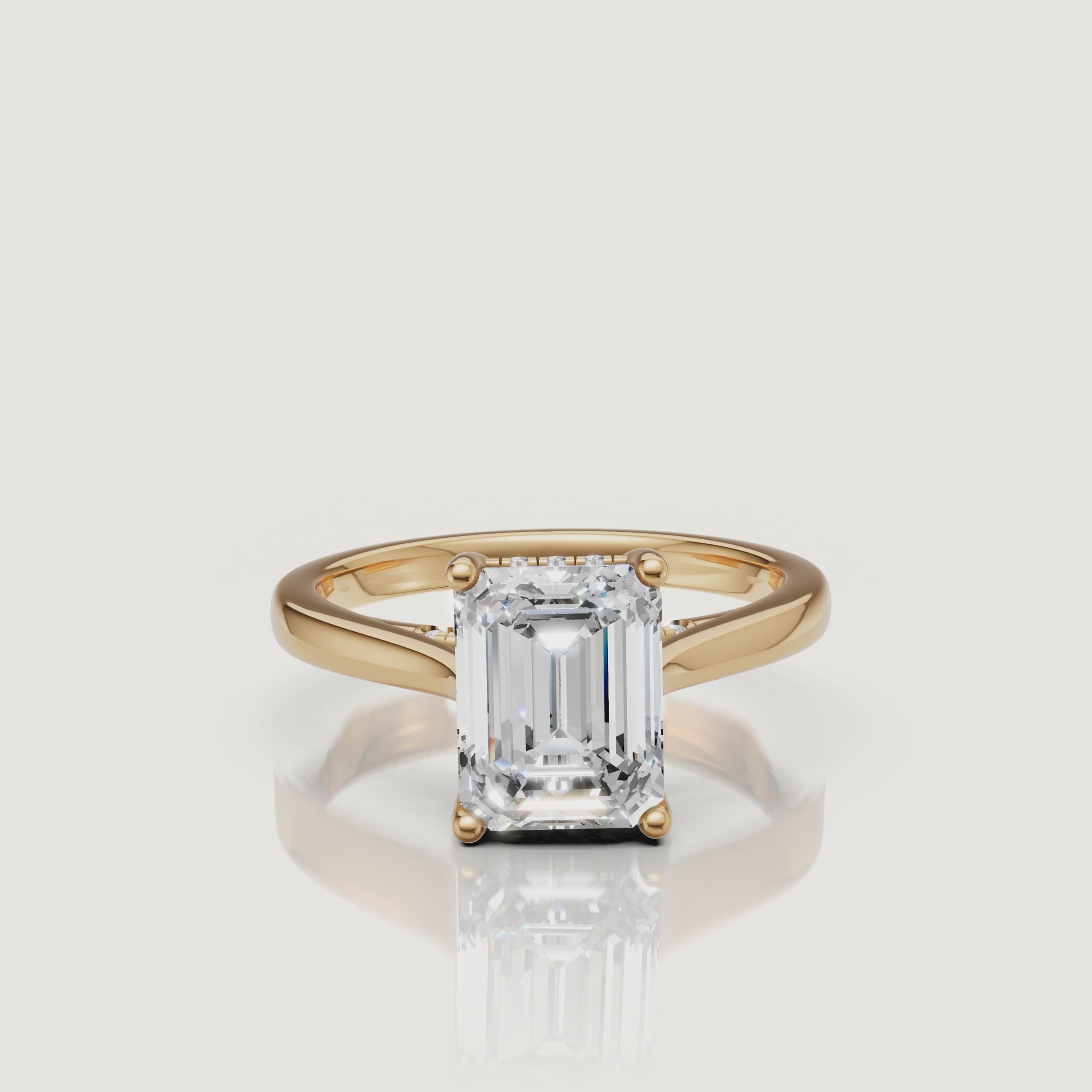 High-resolution 360 view of Raul Diamonds yellow gold emerald cut ring featuring a brilliant hidden halo gallery