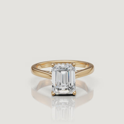 High-resolution 360 view of Raul Diamonds yellow gold emerald cut ring featuring a brilliant hidden halo gallery