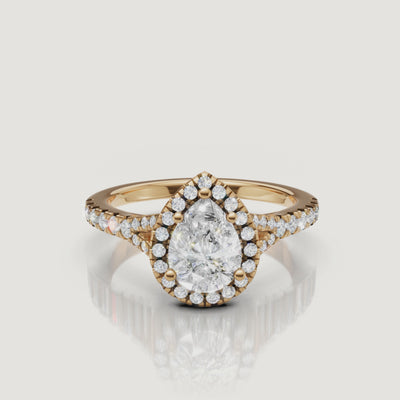 A 360-degree high-definition video of a Raul Diamonds pear-cut engagement ring in yellow gold, highlighting the brilliance of the teardrop center stone and the split shank