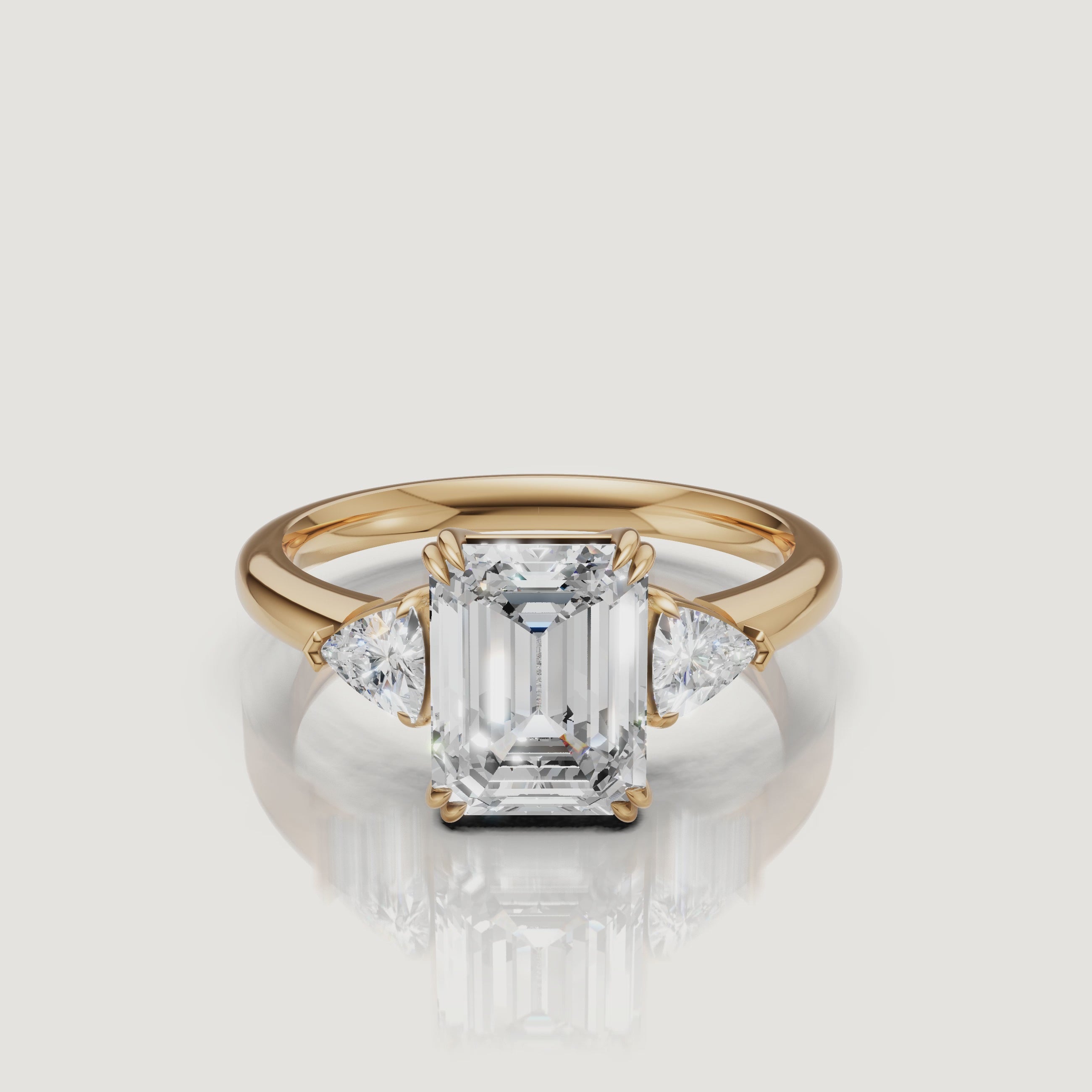 video of emerald cut lab grown diamond engagement ring with trillion side stones in 14k yellow gold