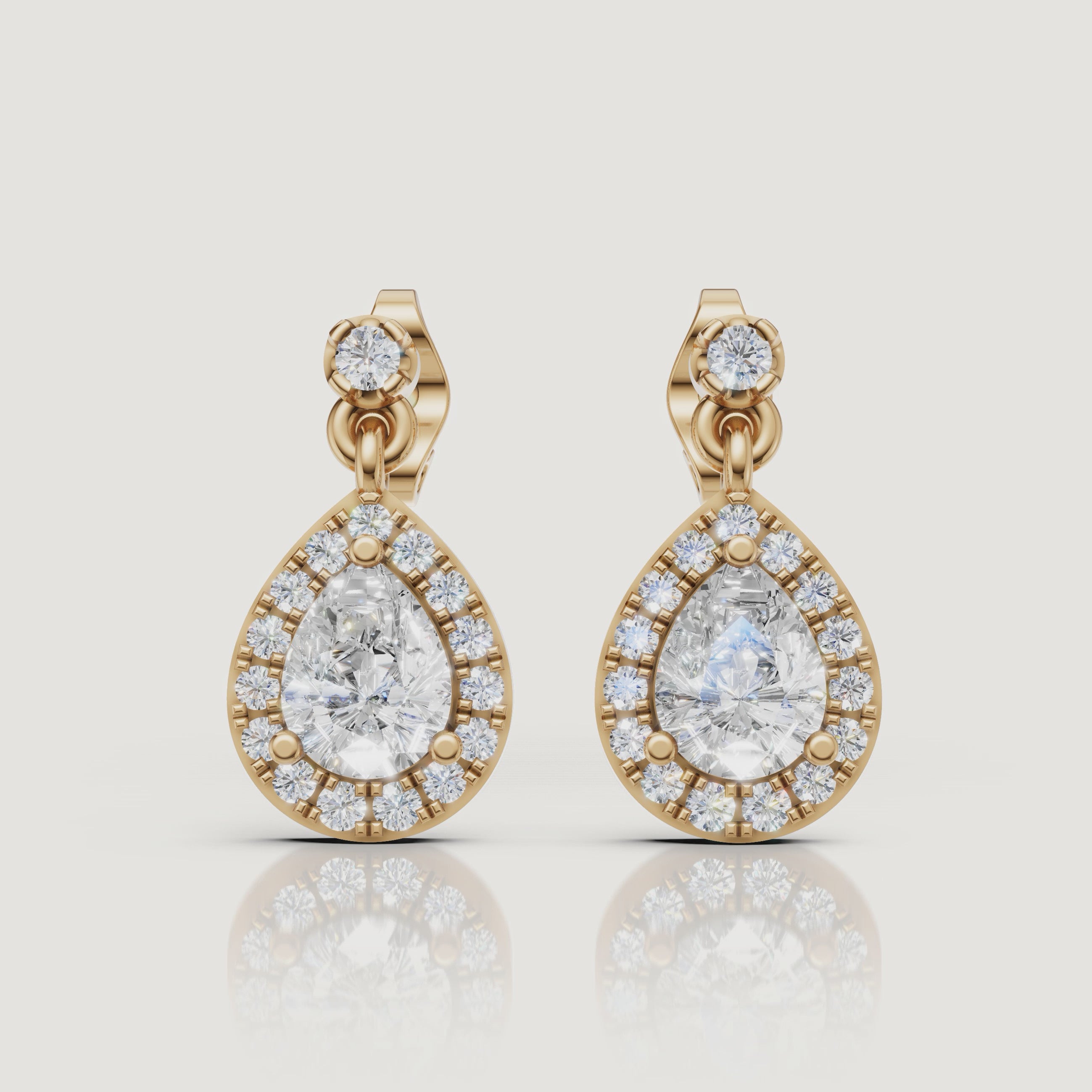 Yellow gold pear halo diamond drop earrings luxury jewelry video by Raul Diamonds