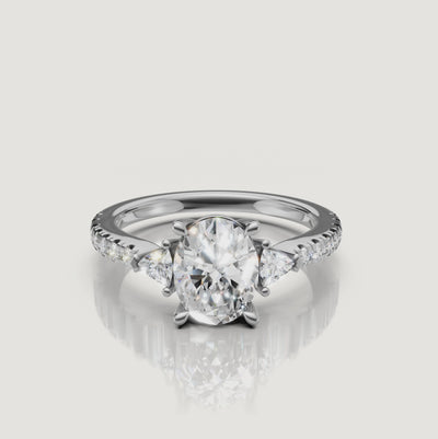 Lifestyle video of a model wearing an oval-shaped diamond ring from Rual Diamonds, demonstrating the elegant profile and fire of the three-stone design