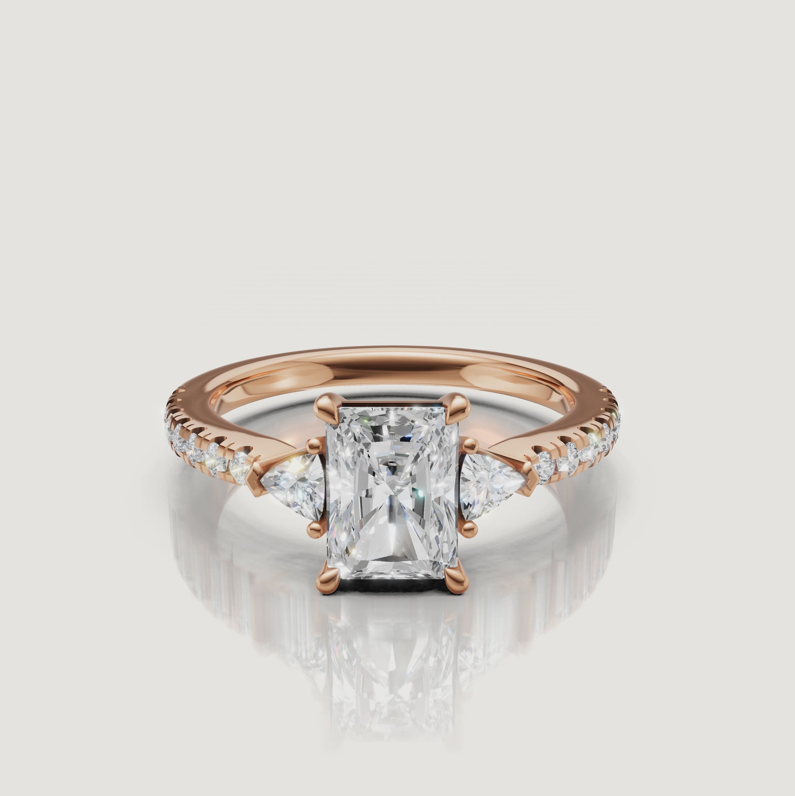 Cinematic close-up of a Rual Diamonds rose gold radiant-cut diamond ring, capturing the warm tones and exceptional sparkle of the three-stone design in motion