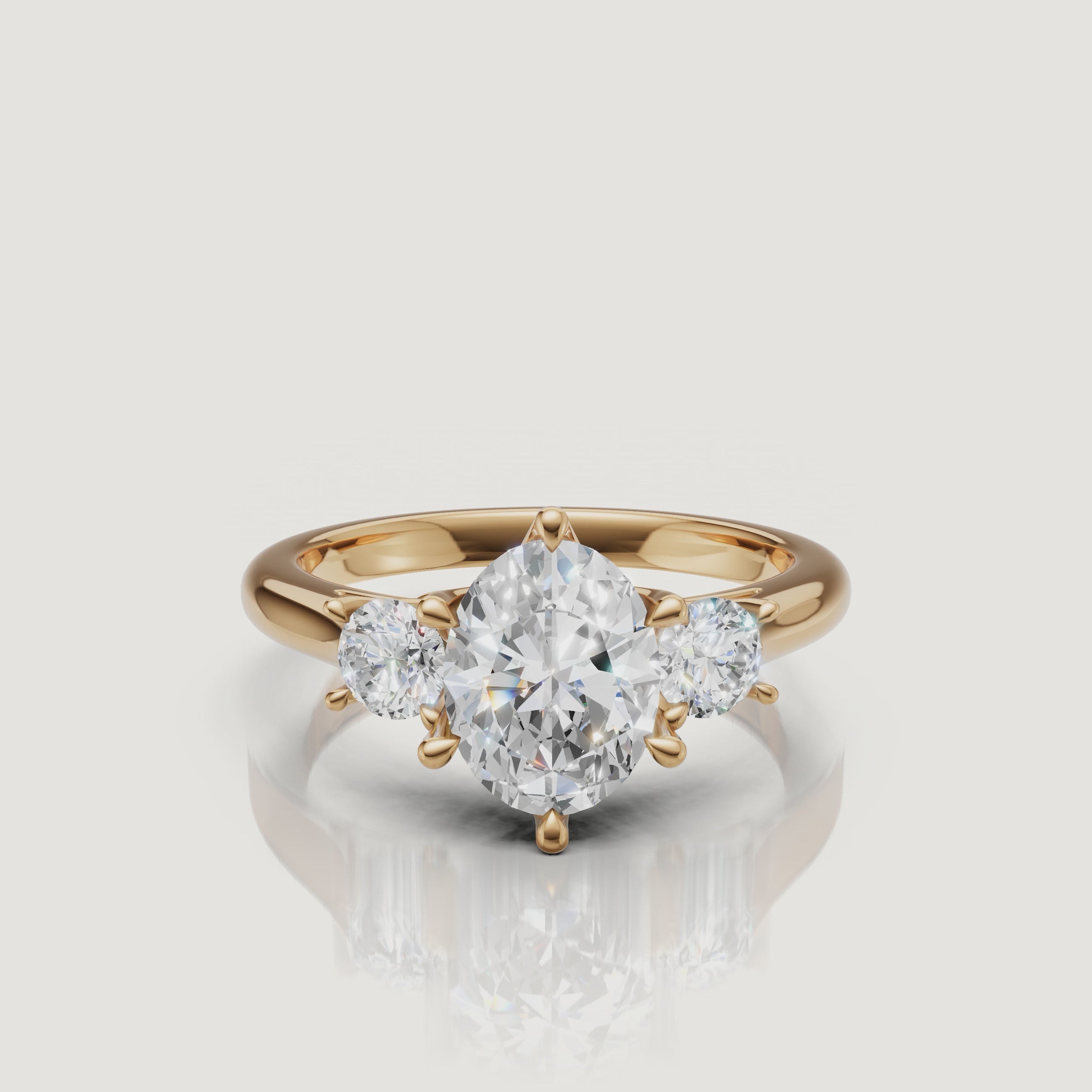 360-degree video showcase of the Raul Diamonds oval cut three-stone ring in yellow gold, highlighting the brilliance of the oval center and pear side diamonds.