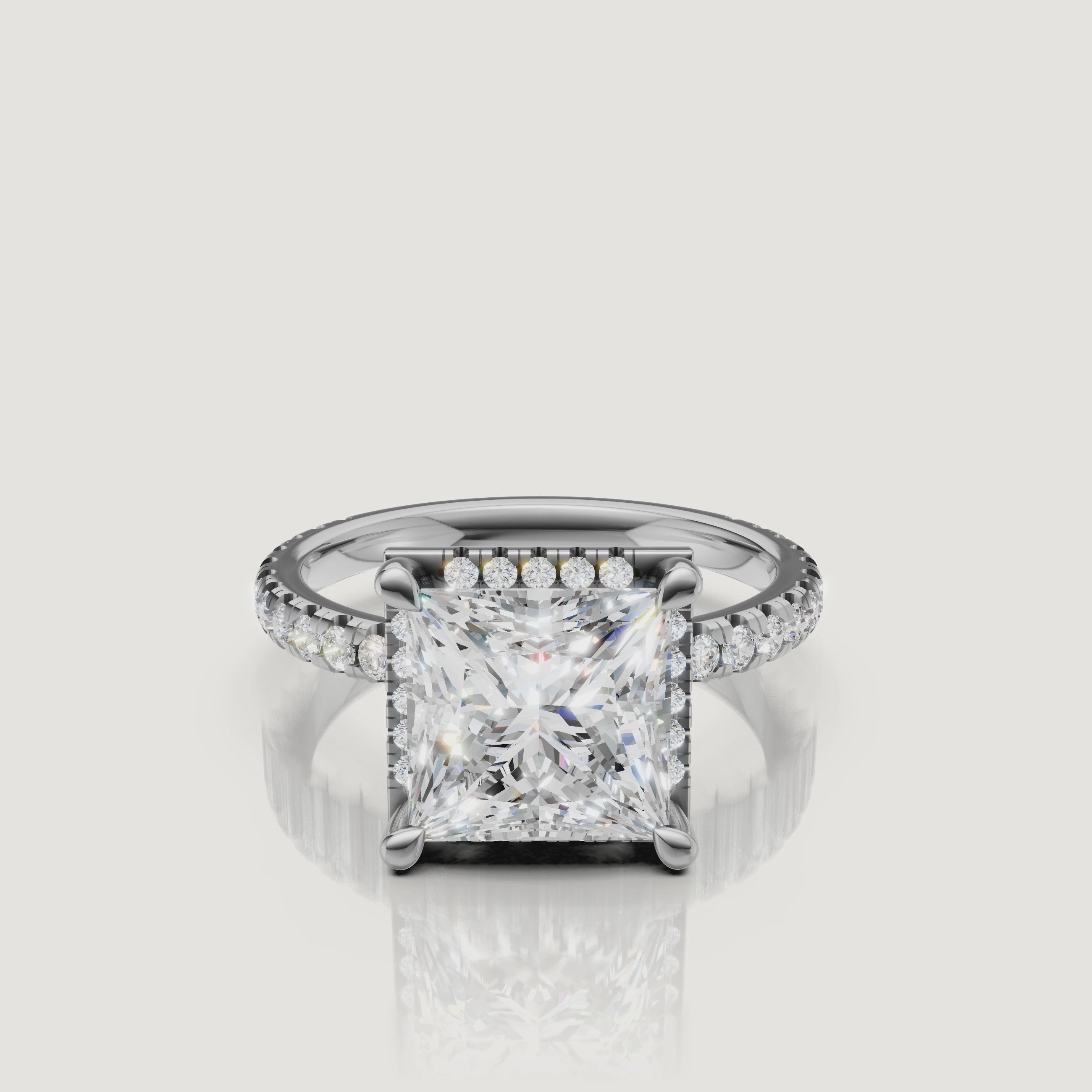Lifestyle video showing the Victoria model wearing a white gold Princess cut engagement ring, focusing on the light performance of the square brilliant stone