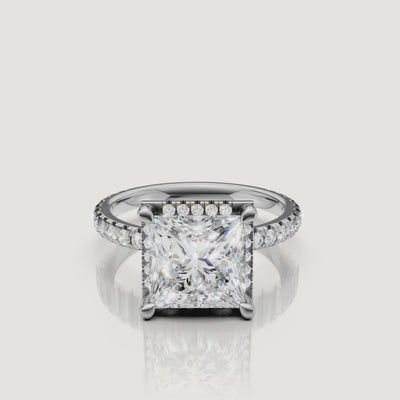 Lifestyle video showing the Victoria model wearing a white gold Princess cut engagement ring, focusing on the light performance of the square brilliant stone