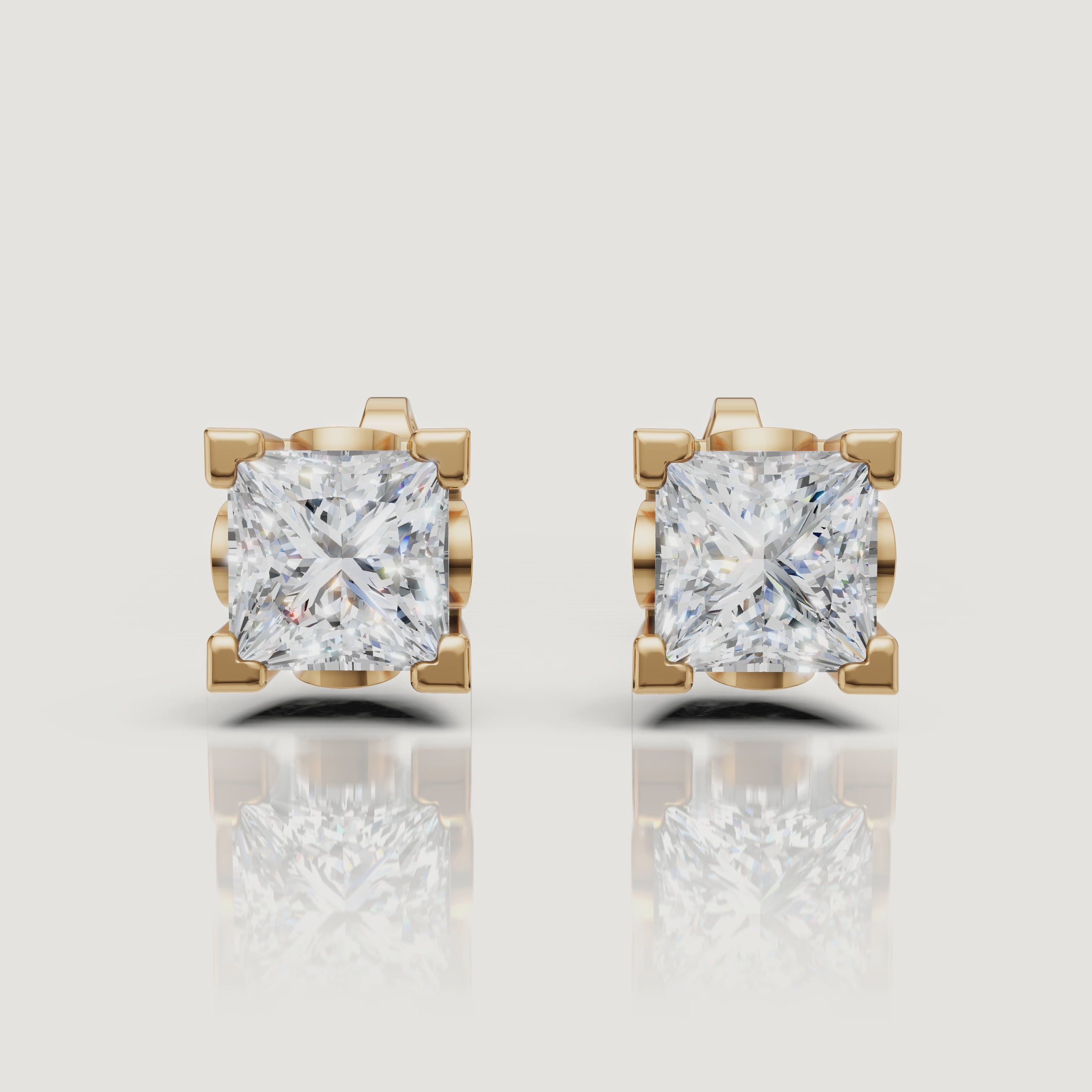 Yellow gold princess cut diamond stud earrings video with brilliant solitaire sparkle by Raul Diamonds