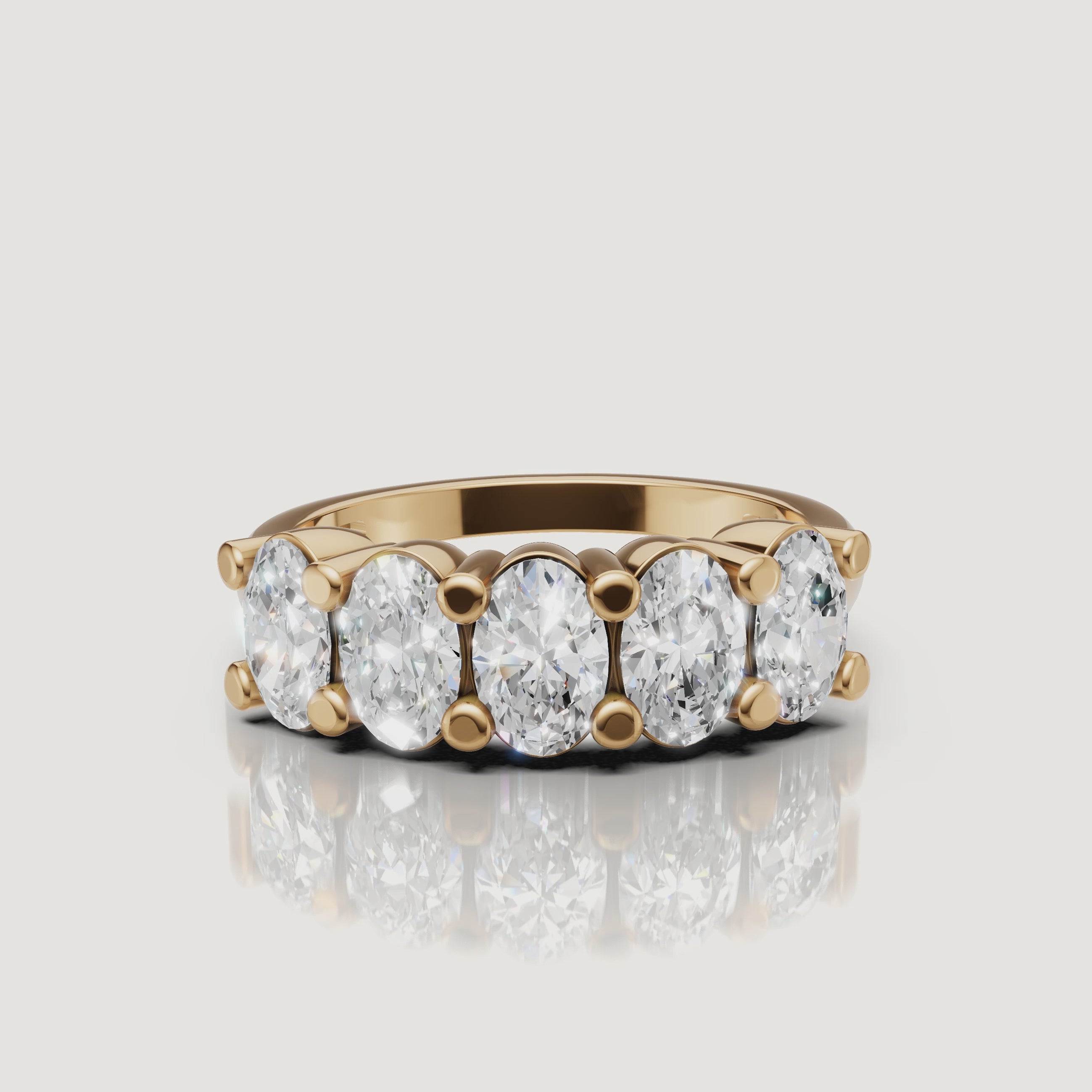 rotating view of oval lab grown diamond five stone anniversary ring in polished gold